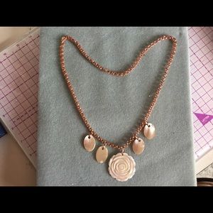 Mother of pearl on rose gold chain.